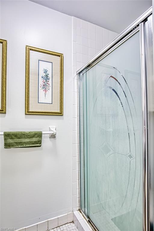 1210 Shady Rest Lane, Unit 14 Naples, FL 34103 - Photo 23 of 30 a bathroom with a shower and a view of a bathroom