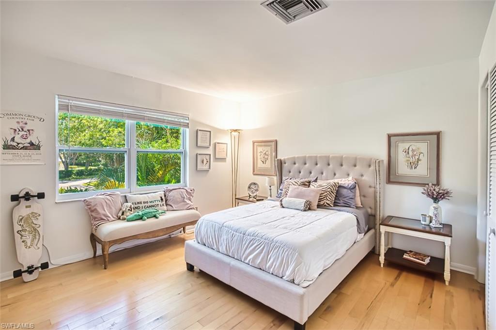 1210 Shady Rest Lane, Unit 14 Naples, FL 34103 - Photo 24 of 30 a bedroom with a bed and a couch