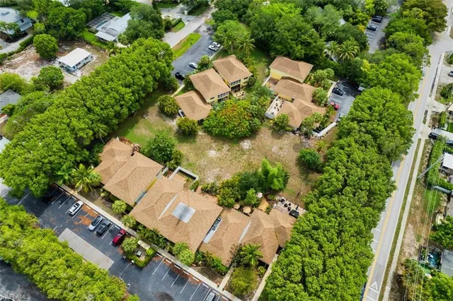 an aerial view of residential house with outdoor space and trees all around