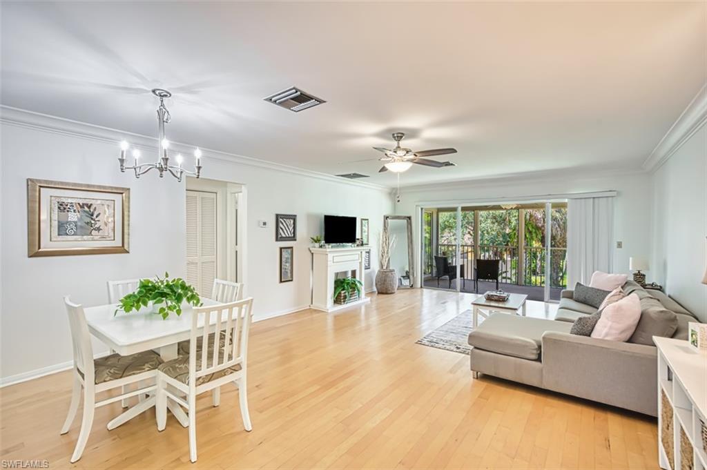 1210 Shady Rest Lane, Unit 14 Naples, FL 34103 - Photo 6 of 30 a living room with furniture and a chandelier