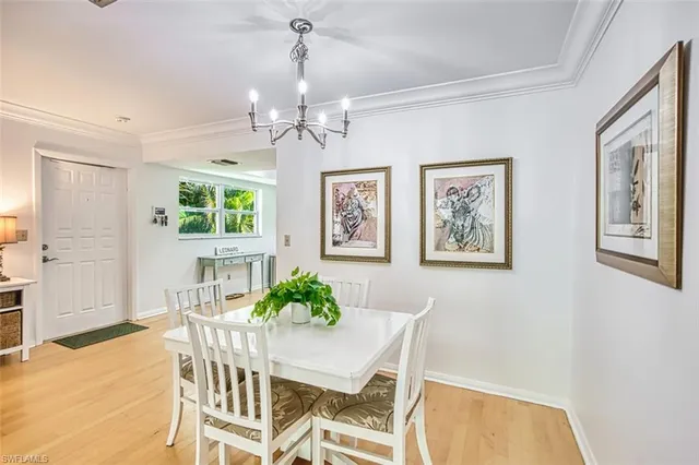a view of a dining room with furniture and a chandelier