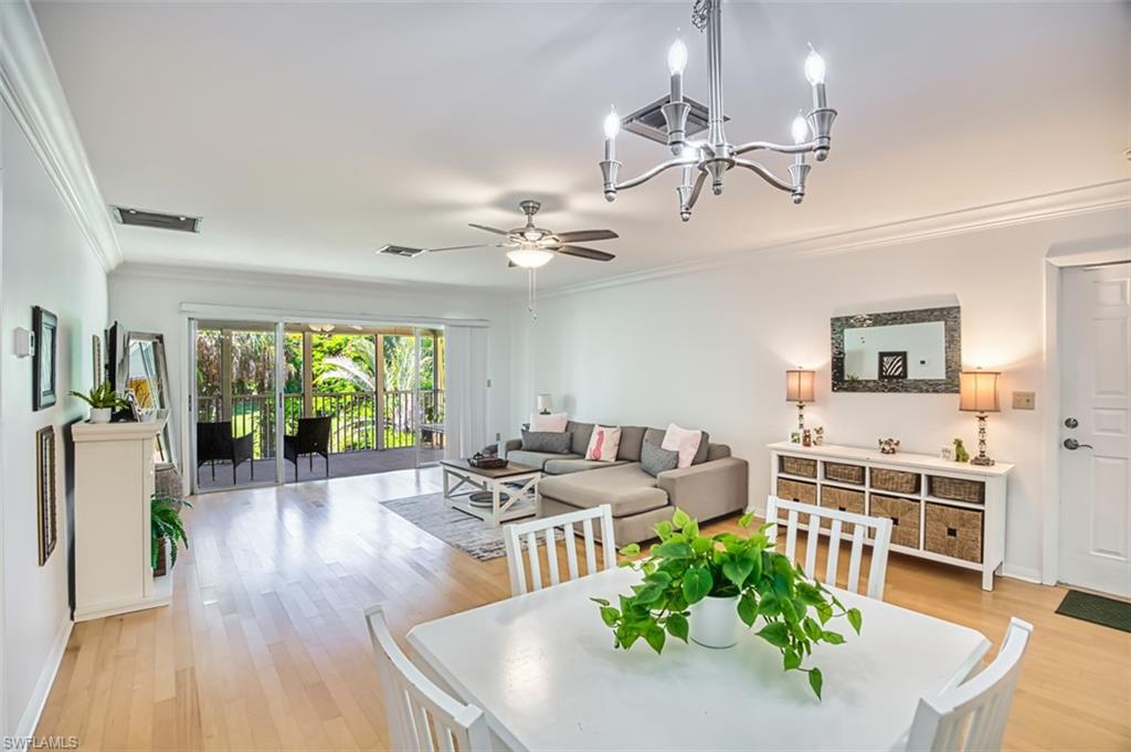 1210 Shady Rest Lane, Unit 14 Naples, FL 34103 - Photo 10 of 30 a living room with furniture and a large window