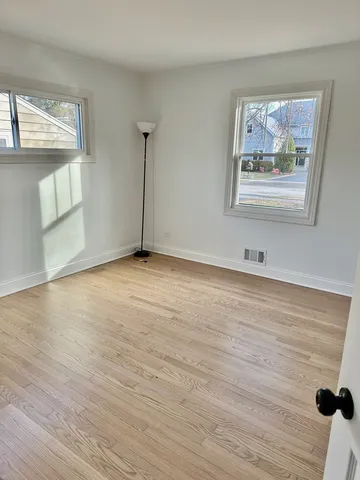 a view of room with window and hardwood floor
