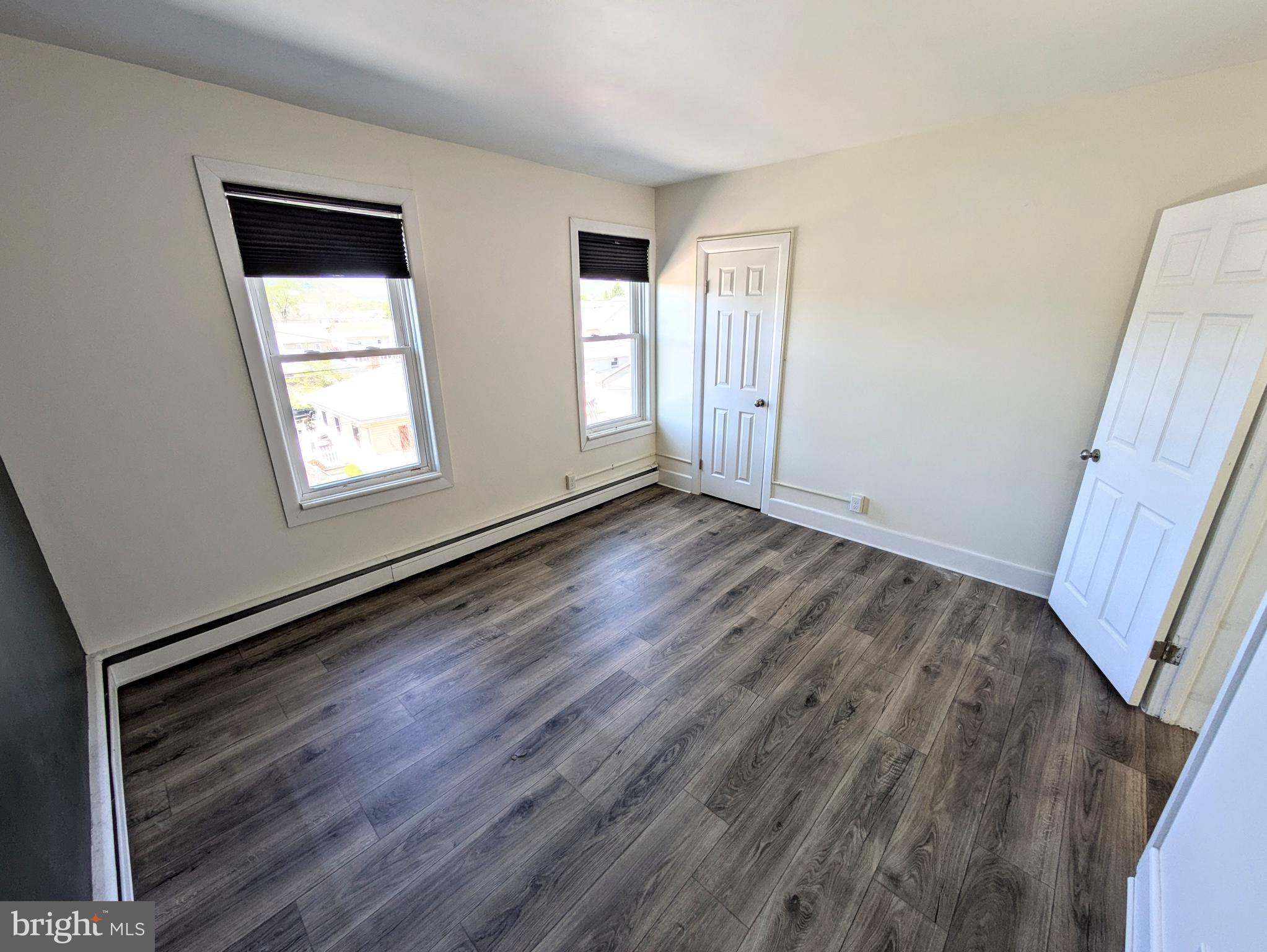 429 West South Street Slatington, PA 18080 - Photo 14 of 22 a view of an empty room with wooden floor and a window