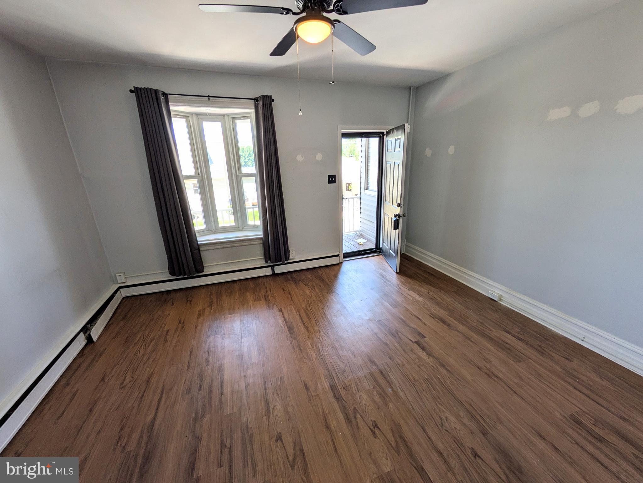 429 West South Street Slatington, PA 18080 - Photo 6 of 22 a view of an empty room with wooden floor and a window