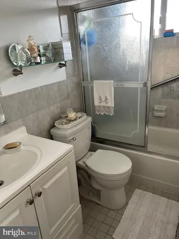 a living room with a couch and a dresser with wooden floor