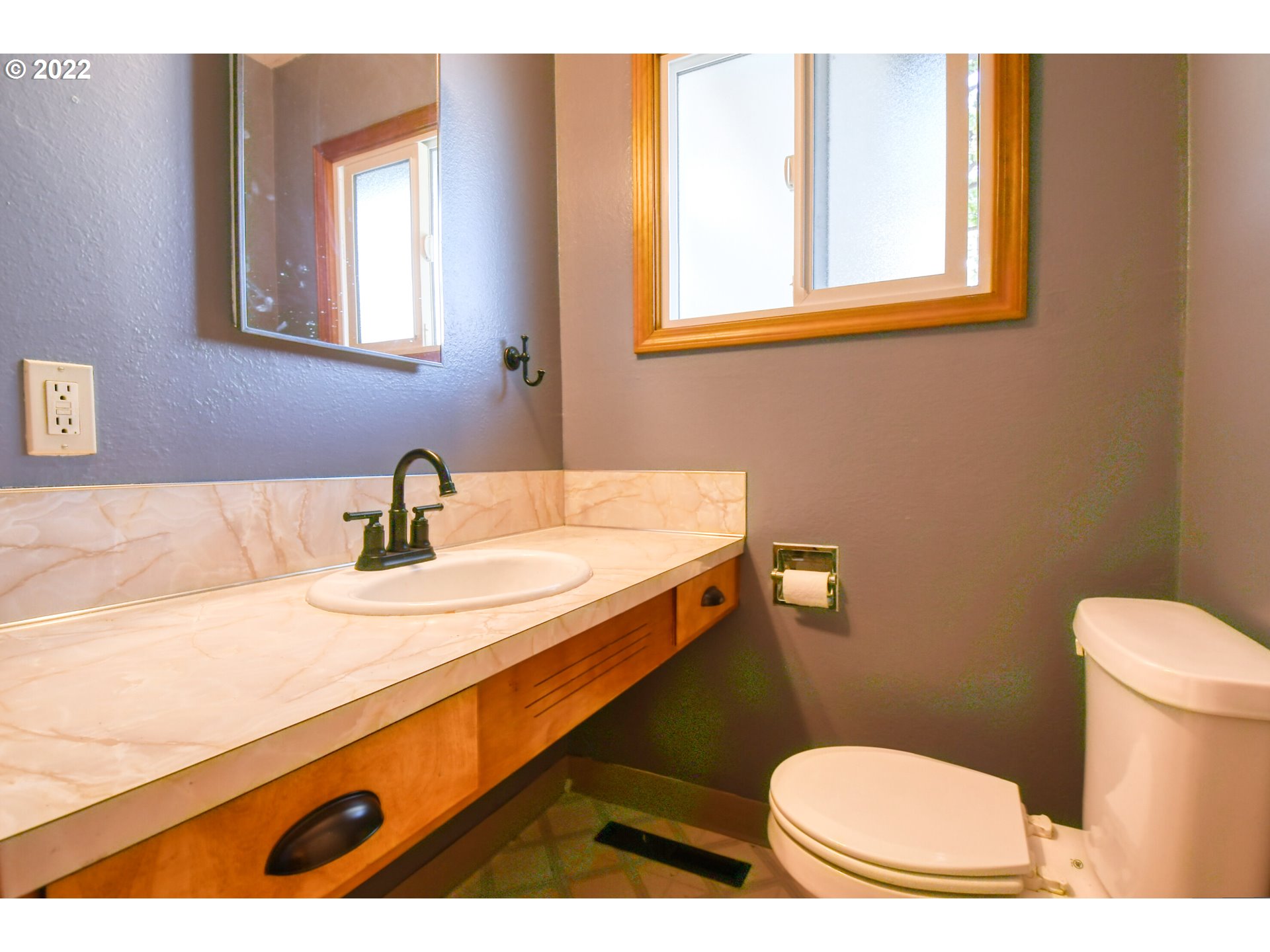 3231 Southwest Isaac Avenue Pendleton, OR 97801 - Photo 23 of 32 a bathroom with a sink mirror vanity and a toilet