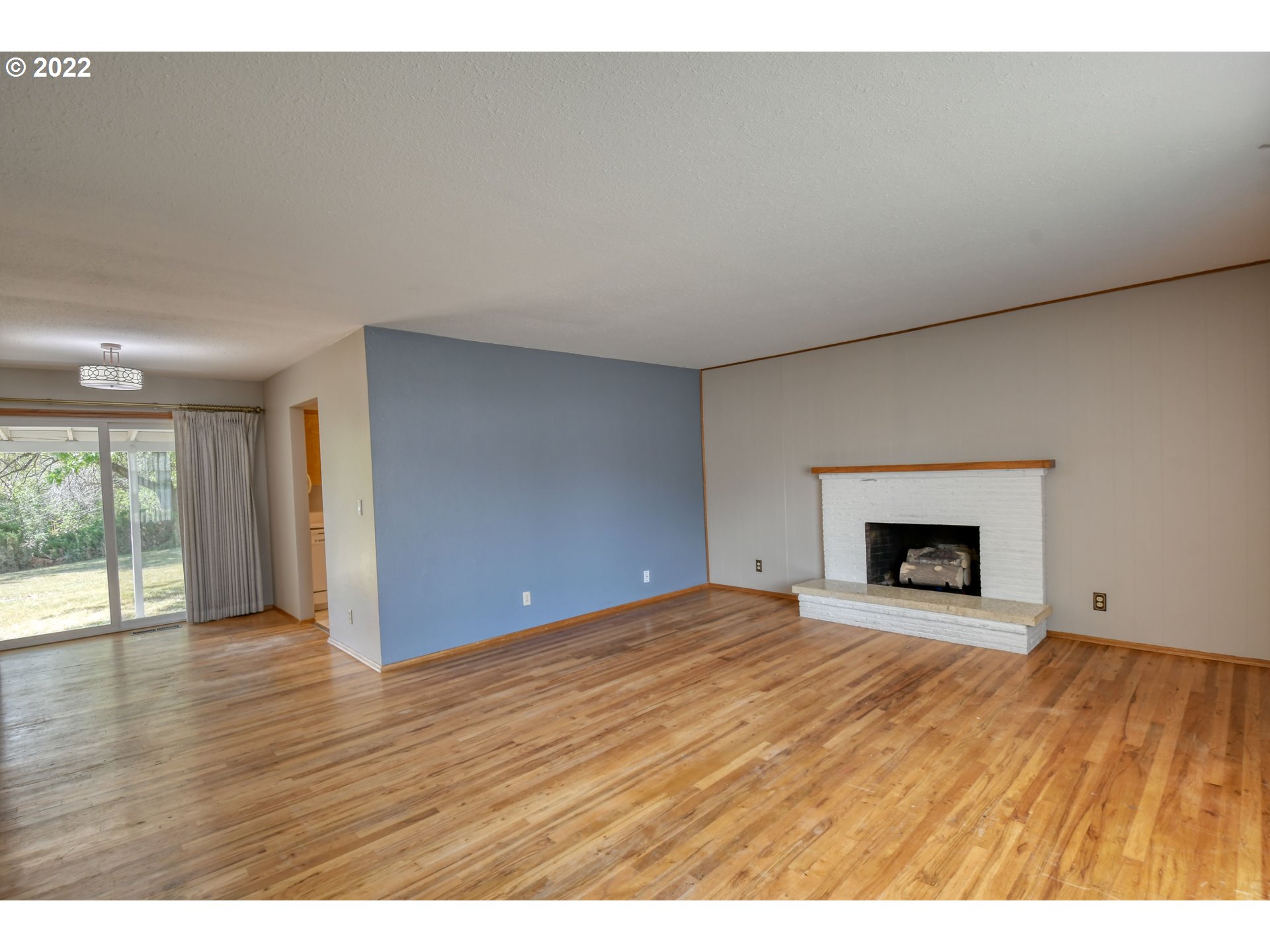 3231 Southwest Isaac Avenue Pendleton, OR 97801 - Photo 3 of 32 a view of an empty room with a fireplace and a window