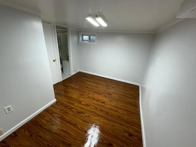 a view of a room with wooden floor