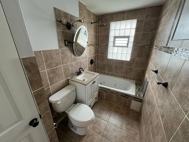 a bathroom with a toilet sink and mirror