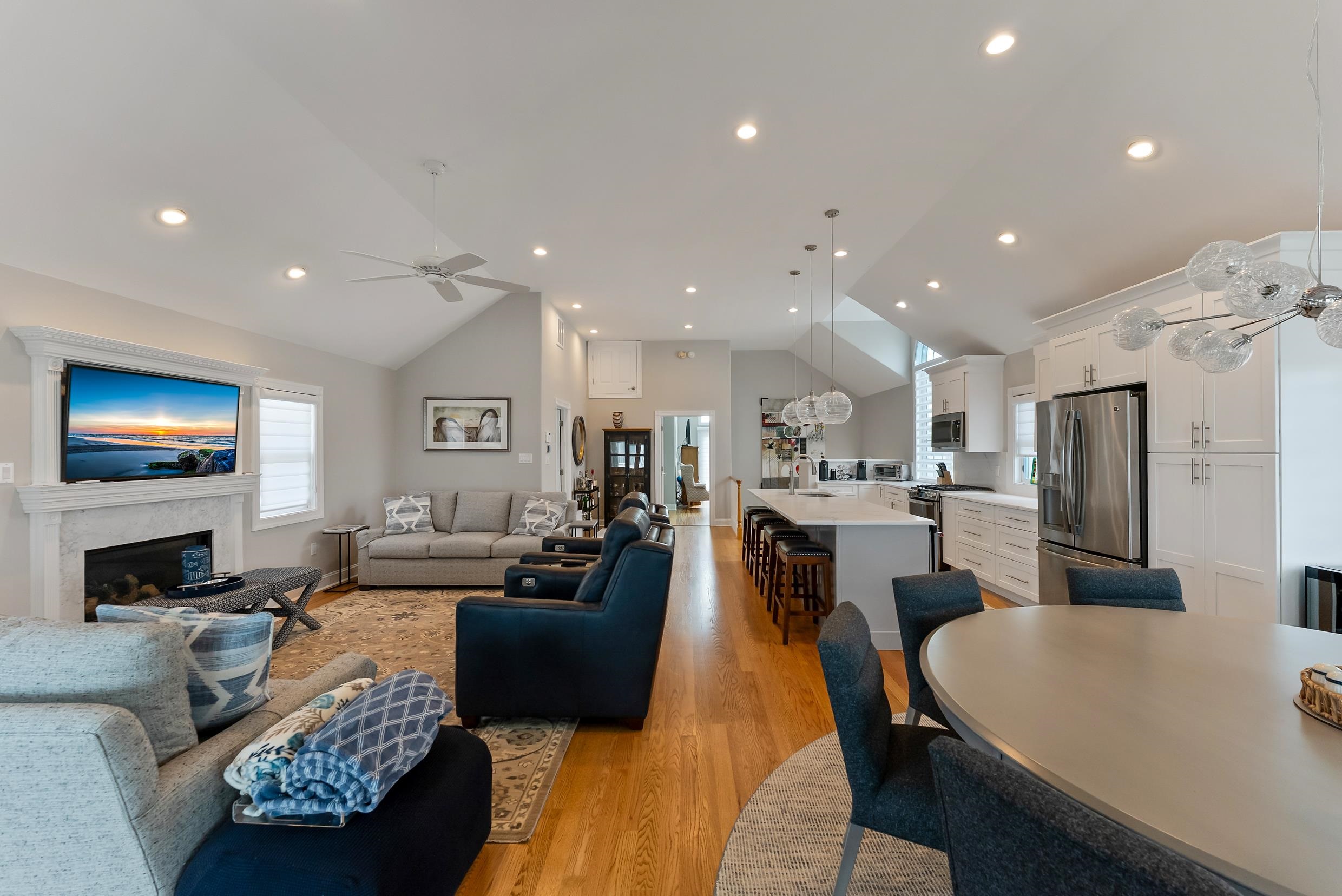 120 113th Street Stone Harbor, NJ 08247 - Photo 12 of 50 a living room with stainless steel appliances furniture a flat screen tv and a chandelier