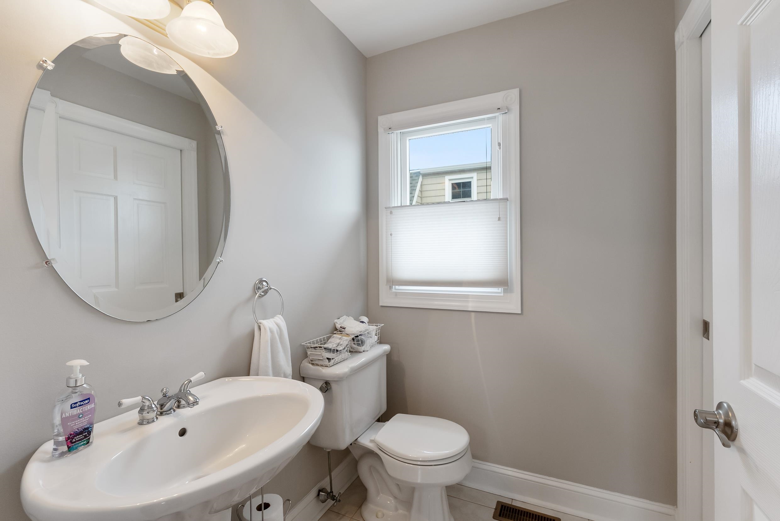 120 113th Street Stone Harbor, NJ 08247 - Photo 17 of 50 a bathroom with a sink mirror and toilet