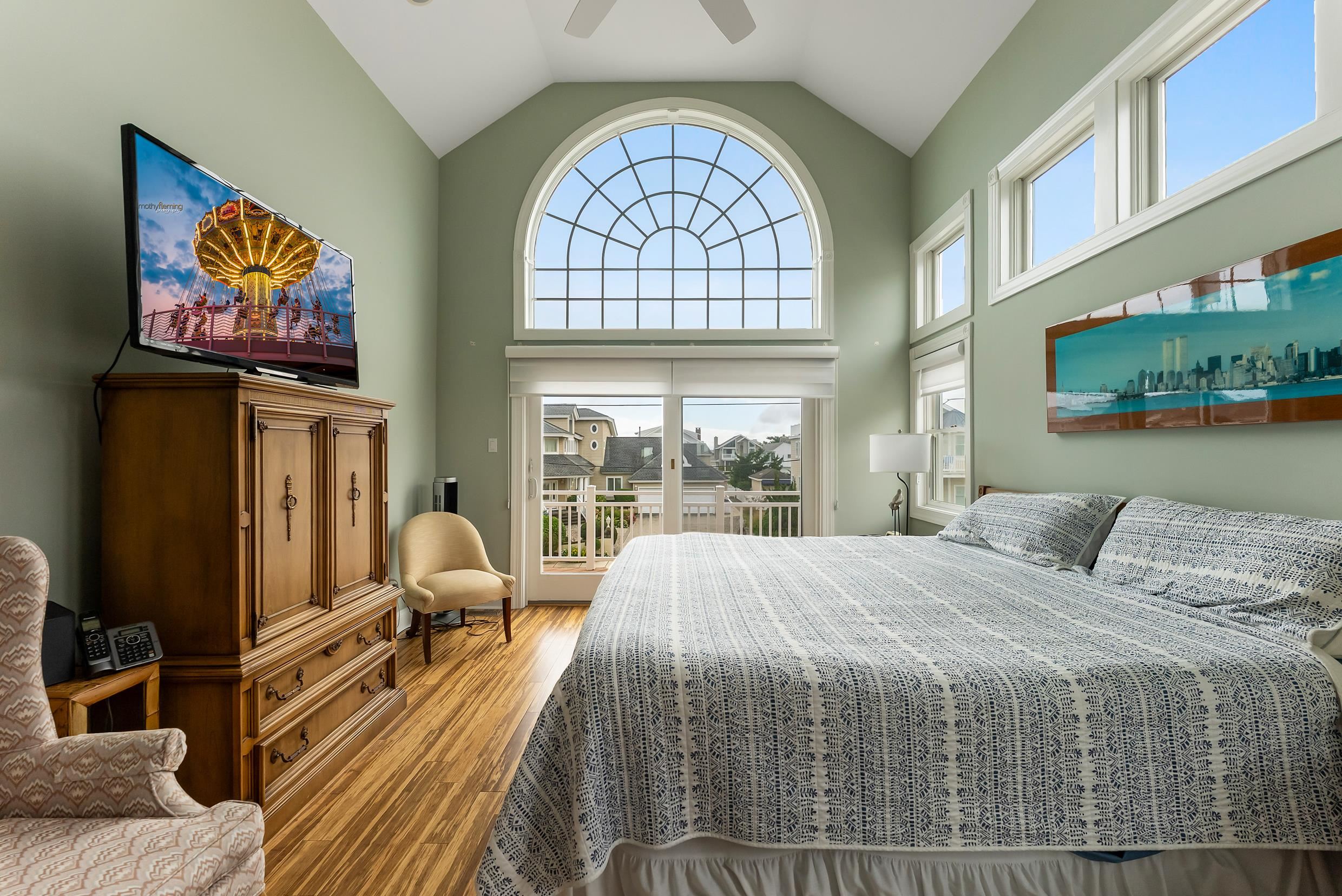120 113th Street Stone Harbor, NJ 08247 - Photo 18 of 50 a bedroom with a bed a dresser next to a window