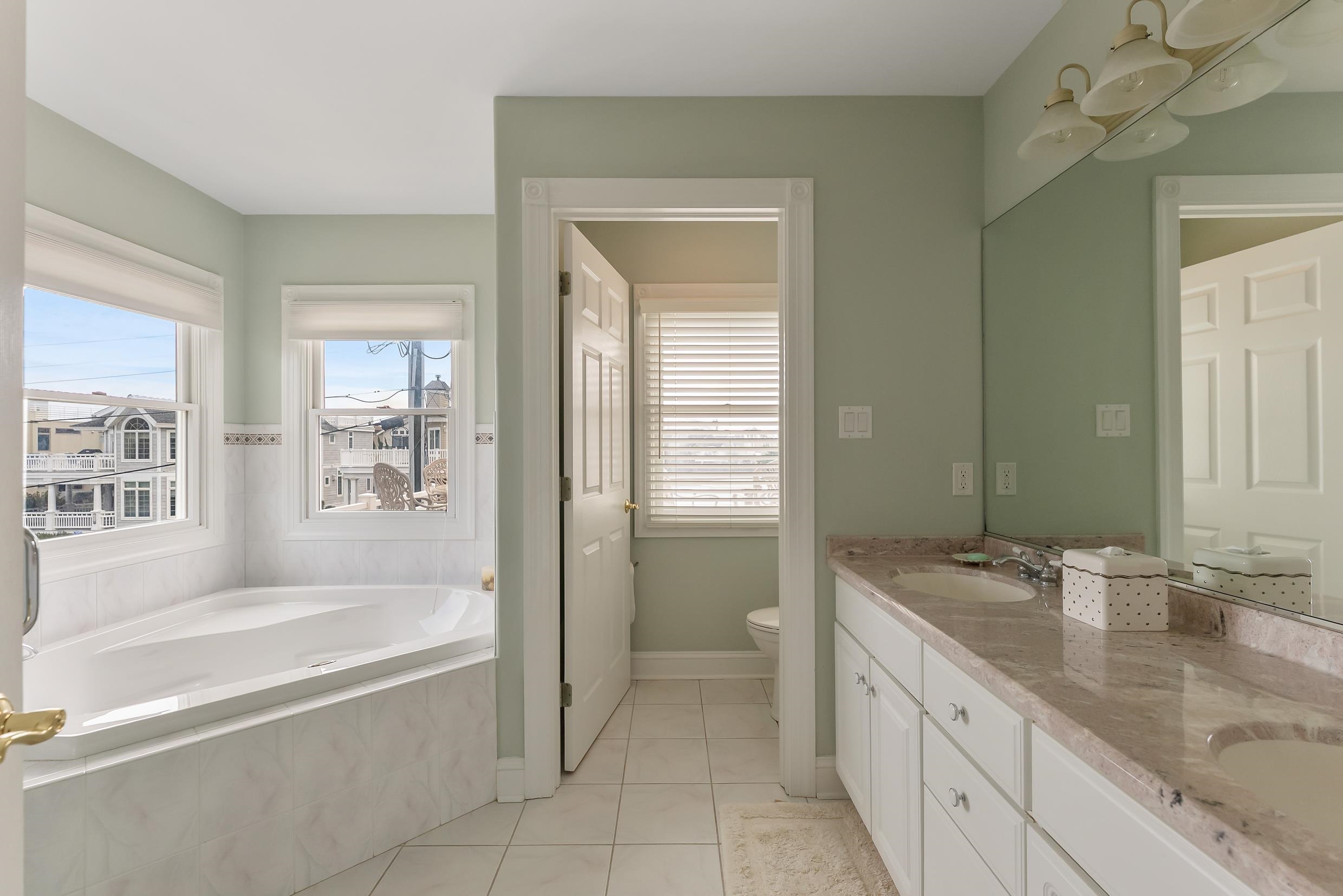 120 113th Street Stone Harbor, NJ 08247 - Photo 20 of 50 a spacious bathroom with sink shower bathtub and next to a window
