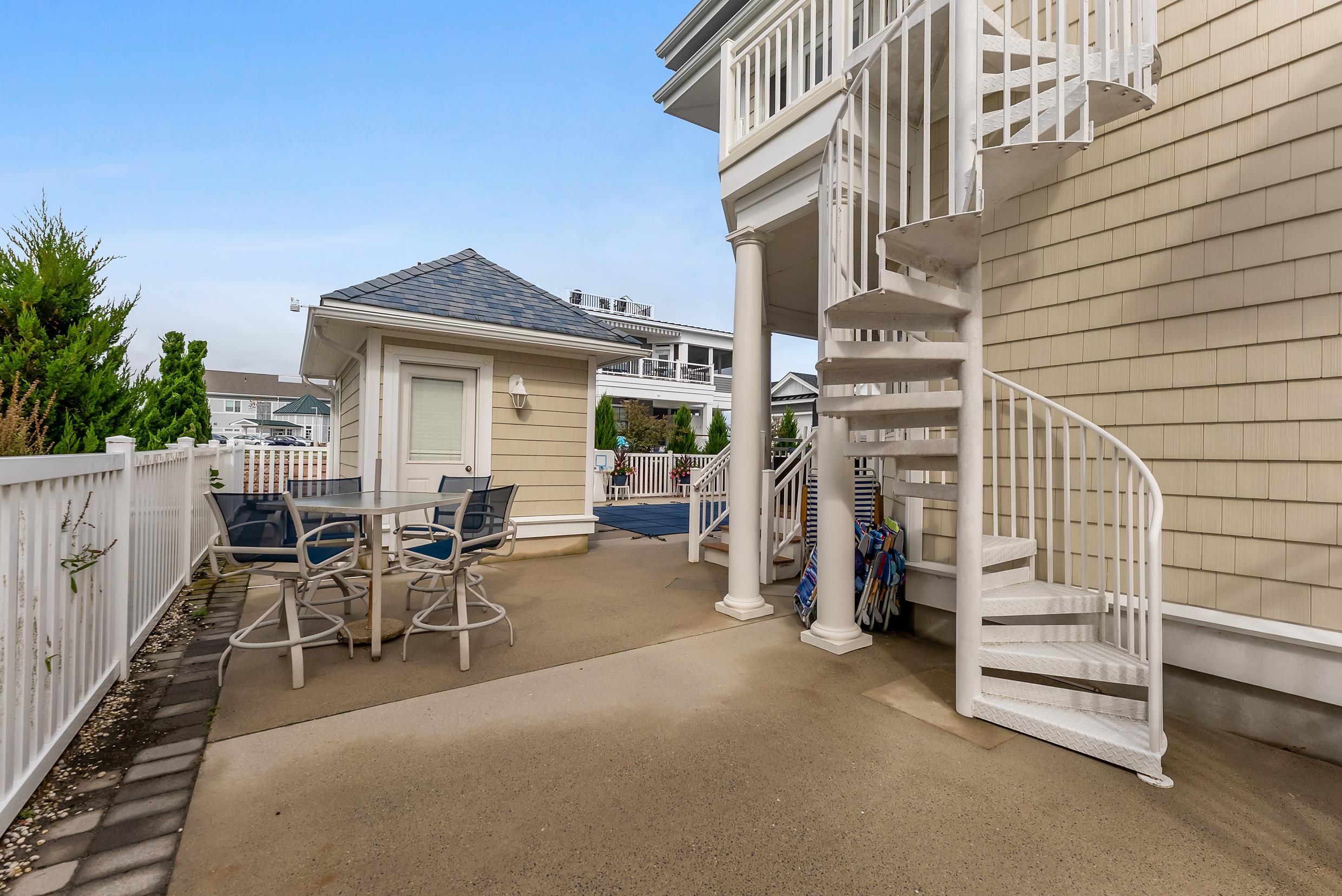 120 113th Street Stone Harbor, NJ 08247 - Photo 26 of 50 a view of a patio with table and chairs and wooden floor