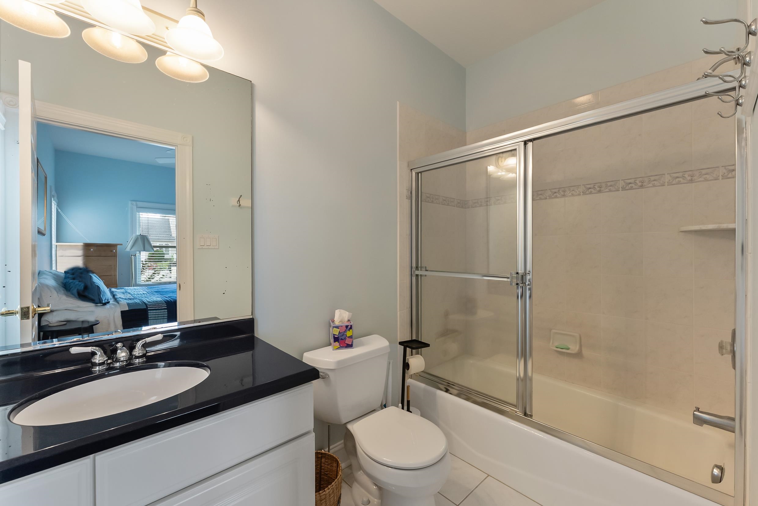 120 113th Street Stone Harbor, NJ 08247 - Photo 42 of 50 a bathroom with a granite countertop sink toilet mirror and shower