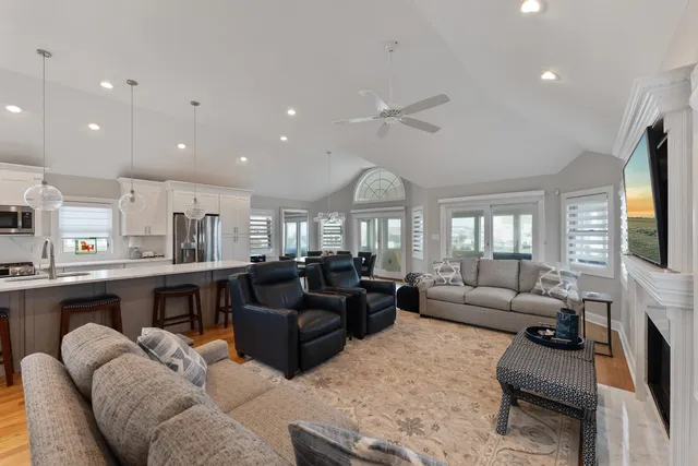 a living room with furniture fireplace and flat screen tv