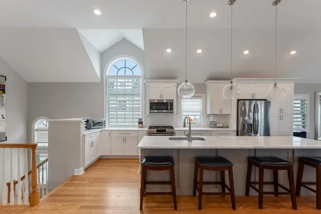 a large kitchen with a table and chairs