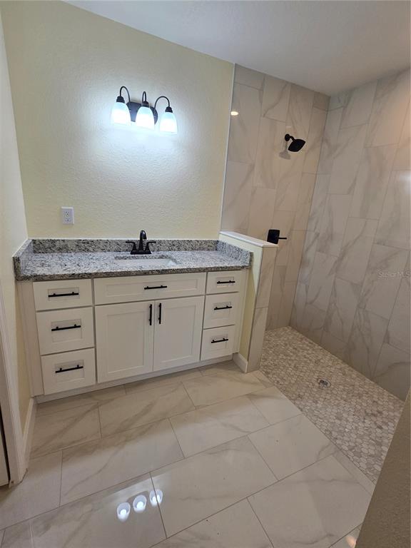 2988 Southwest Bonable Drive Dunnellon, FL 34431 - Photo 16 of 22 a bathroom with a granite countertop sink a mirror and a