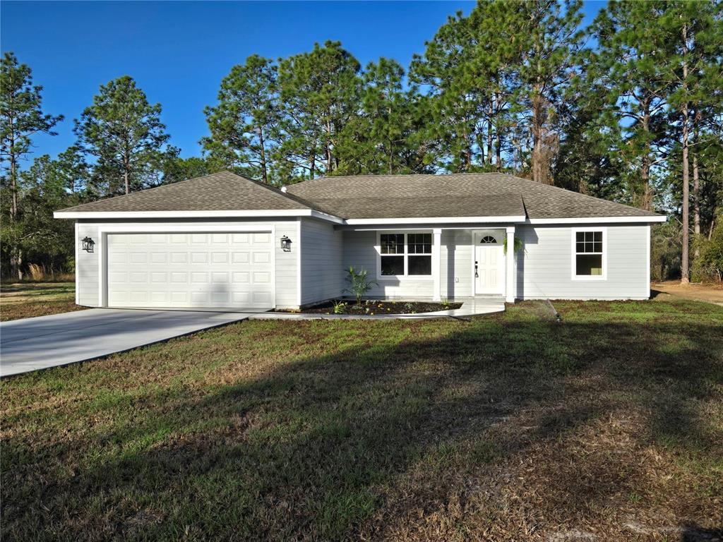 2988 Southwest Bonable Drive Dunnellon, FL 34431 - Photo 2 of 22 a front view of a house with a garden