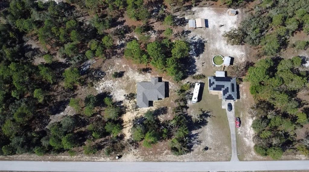2988 Southwest Bonable Drive Dunnellon, FL 34431 - Photo 22 of 22 an aerial view of a house with a yard and trees
