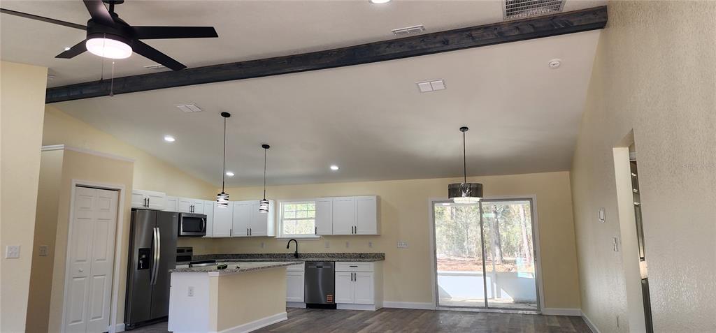 2988 Southwest Bonable Drive Dunnellon, FL 34431 - Photo 3 of 22 a kitchen with kitchen island white cabinets and refrigerator