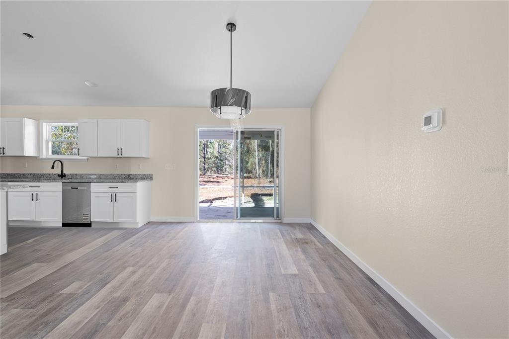 2988 Southwest Bonable Drive Dunnellon, FL 34431 - Photo 5 of 22 a view of a kitchen with a sink wooden floor and a window