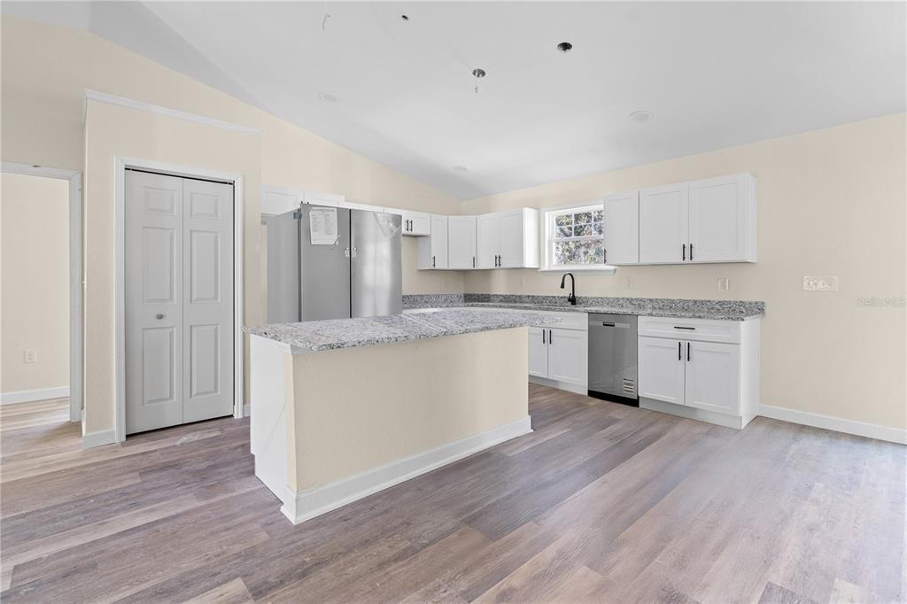 2988 Southwest Bonable Drive Dunnellon, FL 34431 - Photo 6 of 22 a kitchen with granite countertop white cabinets and white appliances