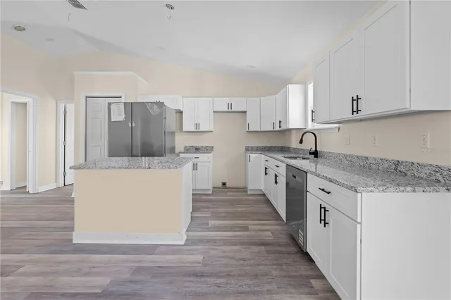 a kitchen with a sink and cabinets