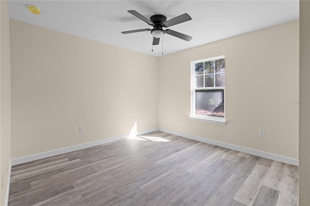 2988 Southwest Bonable Drive Dunnellon, FL 34431 - Photo 9 of 19 wooden floor in an empty room with a window
