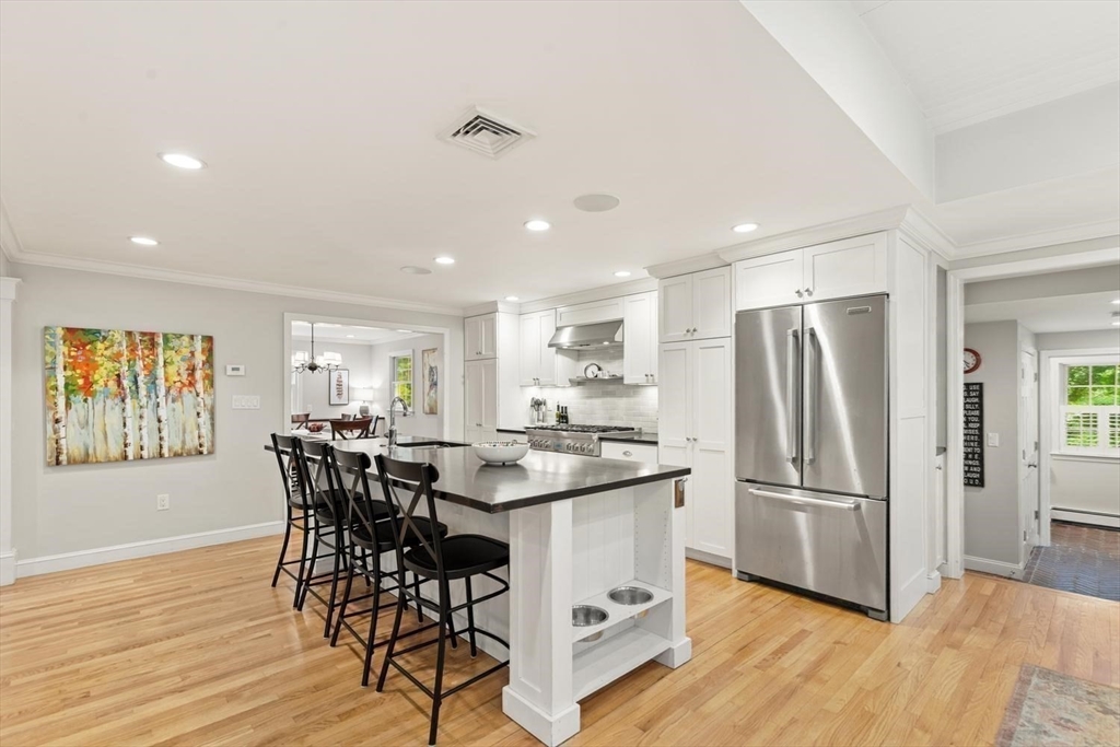 105 Thornberry Road Winchester, MA 01890 - Photo 8 of 35 a kitchen with stainless steel appliances granite countertop a dining table chairs refrigerator and sink