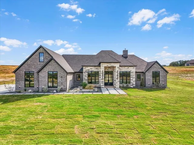 a front view of house with yard and swimming pool
