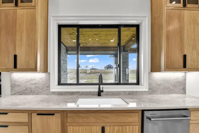 a kitchen with sink and window