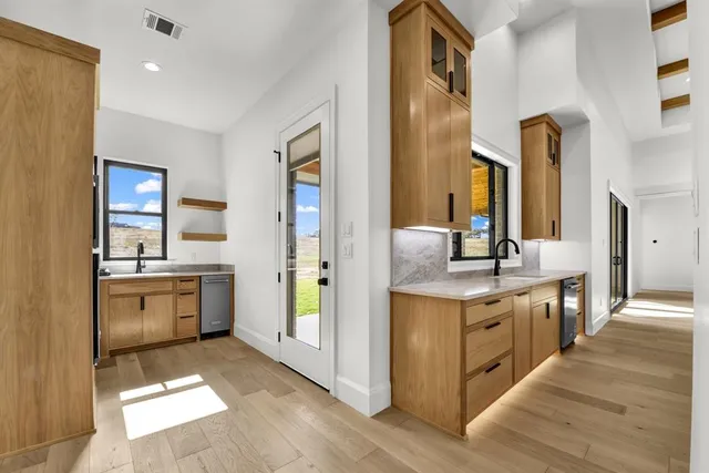 a large kitchen with a stove and a sink