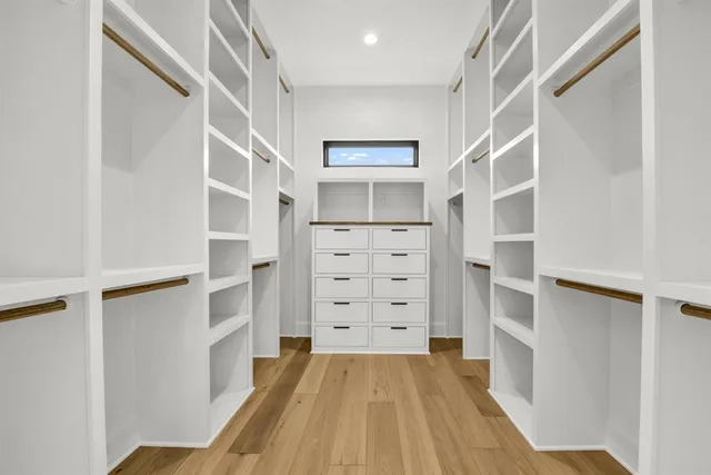 a view of walk in closet with empty racks
