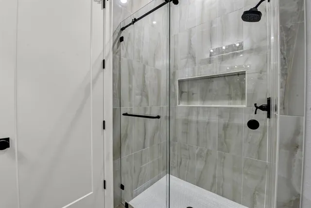 a bathroom with a glass shower door