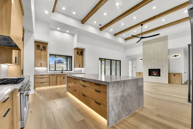 a kitchen with stainless steel appliances granite countertop a stove and a sink