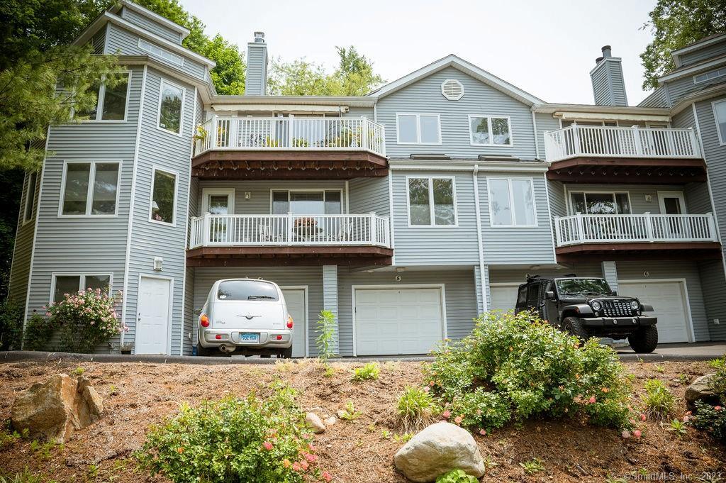 5 Quarry Dock Road, Unit 5 Branford, CT 06405 - Photo 1 of 1 a front view of a house with a yard and garage