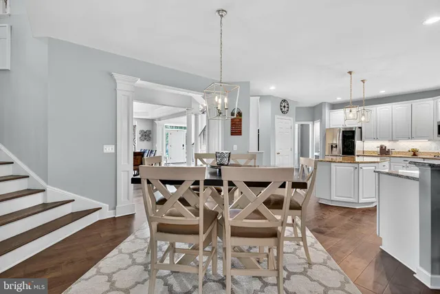 a view of a hallway with wooden floor and stairs