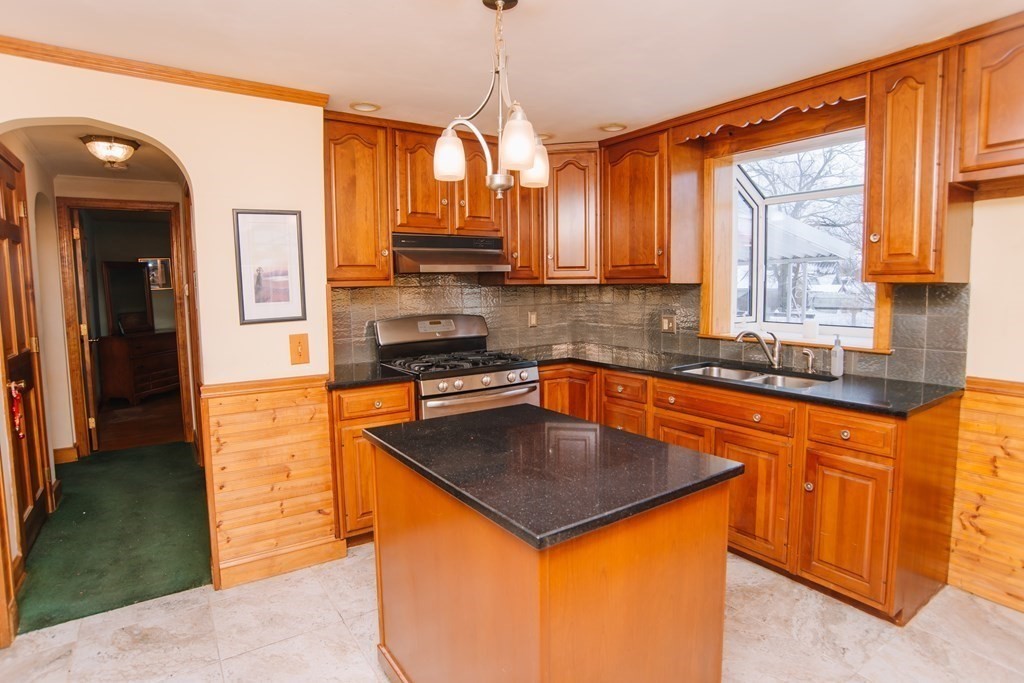 67 Campechi Street Springfield, MA 01104 - Photo 11 of 41 a kitchen with stainless steel appliances granite countertop a sink a stove and a refrigerator