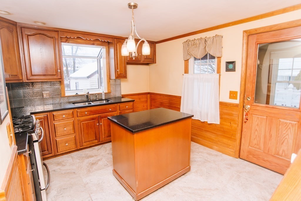 67 Campechi Street Springfield, MA 01104 - Photo 12 of 41 a kitchen with granite countertop a sink and cabinets