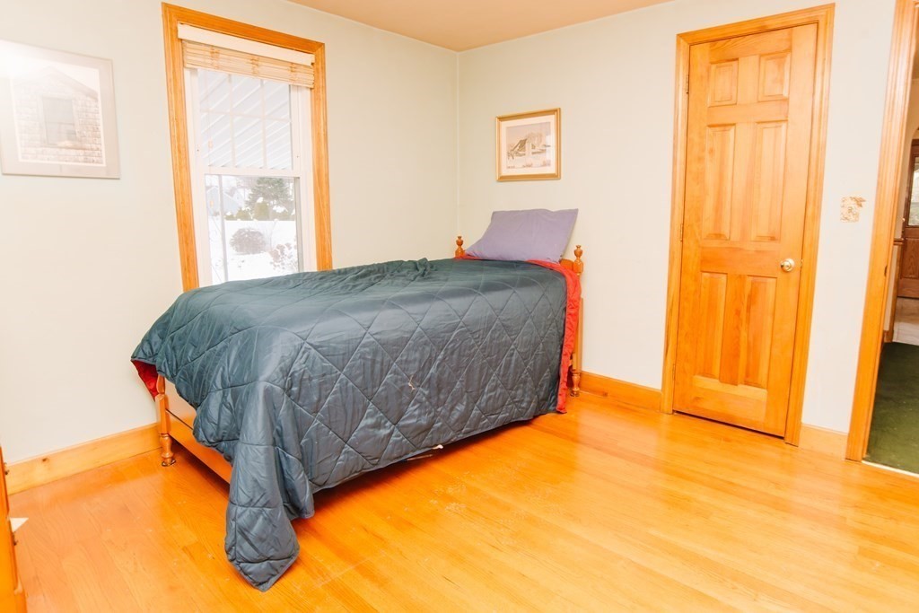 67 Campechi Street Springfield, MA 01104 - Photo 20 of 41 a bedroom with a bed and wooden floor