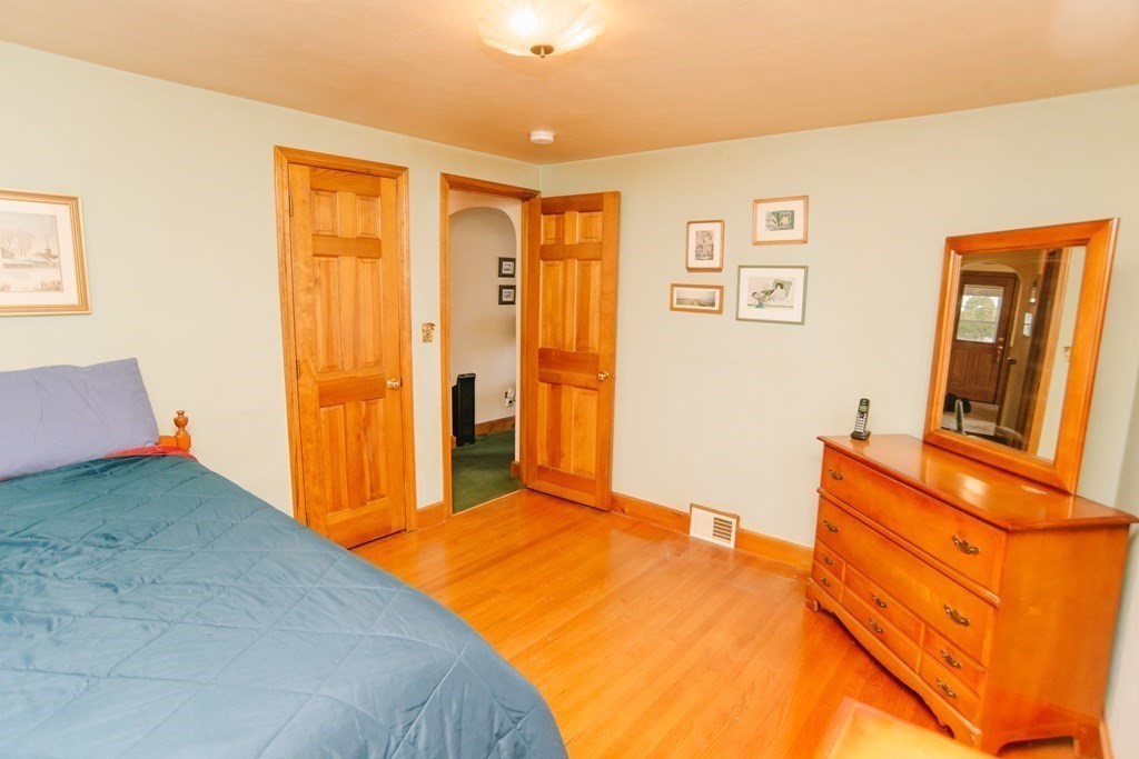 67 Campechi Street Springfield, MA 01104 - Photo 22 of 41 a bedroom with a bed and wooden floor