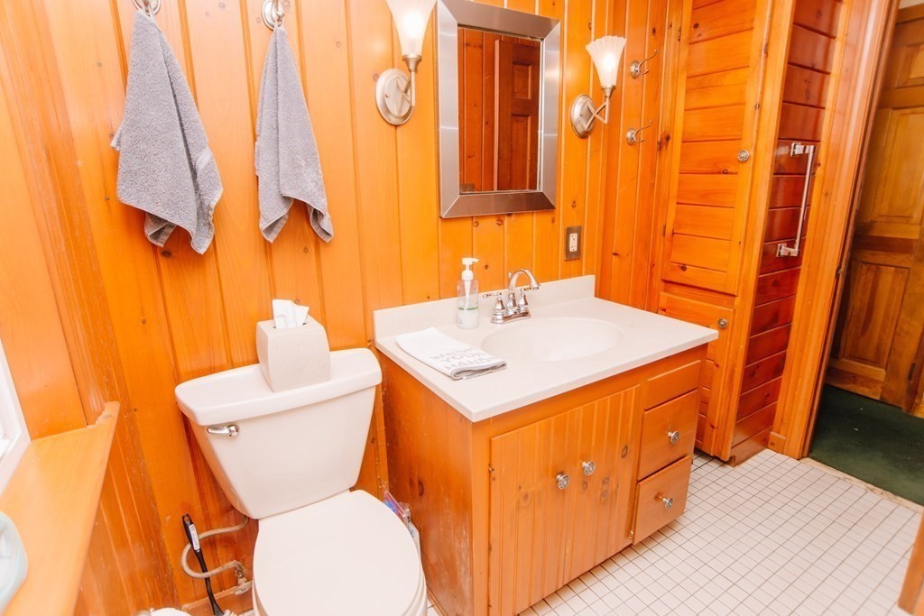 67 Campechi Street Springfield, MA 01104 - Photo 25 of 41 a bathroom with a sink a toilet and shower curtain