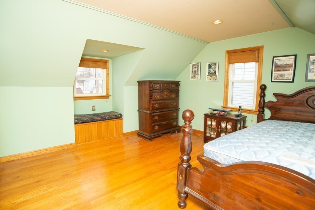 67 Campechi Street Springfield, MA 01104 - Photo 27 of 41 a bedroom with a bed and wooden floor