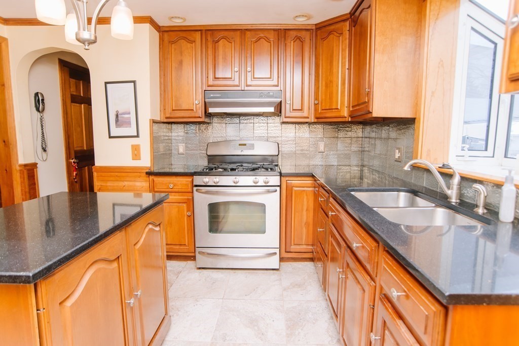 67 Campechi Street Springfield, MA 01104 - Photo 6 of 41 a kitchen with stainless steel appliances granite countertop a sink a stove and cabinets