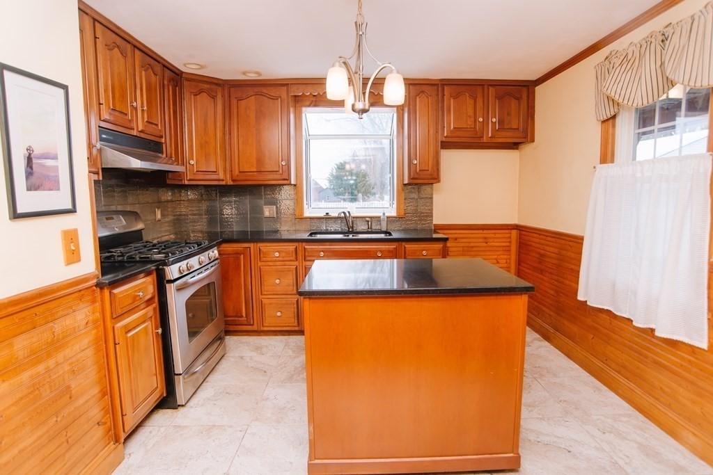 67 Campechi Street Springfield, MA 01104 - Photo 8 of 41 a kitchen with stainless steel appliances granite countertop a sink and a refrigerator