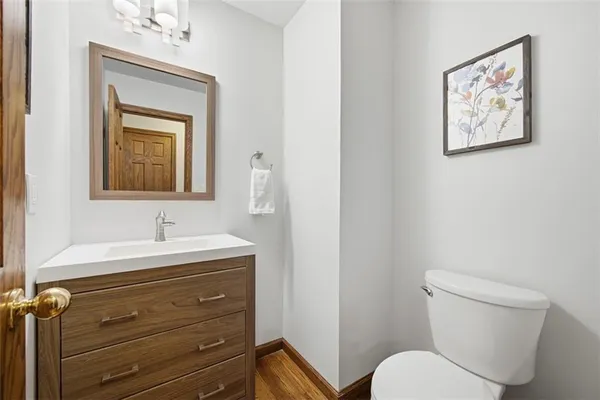 a bathroom with a toilet a sink and mirror