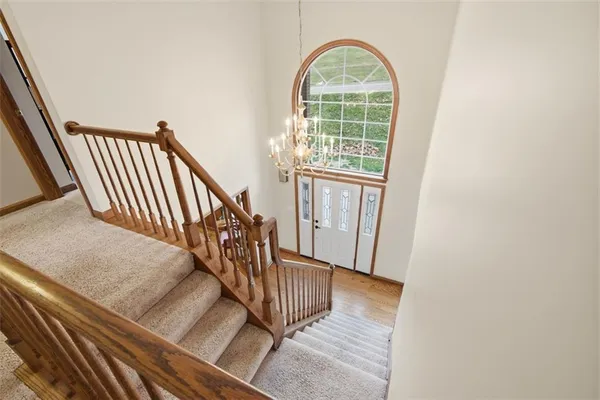 a view of staircase with wooden floor and a window