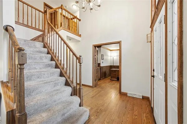 a view of a hallway with wooden floor and entryway